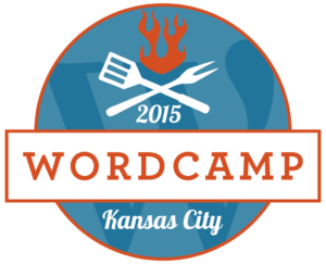 Logo for WordCamp Kansas City 2015 with barbecue utensils under a flame, celebrating KC's BBQ culture.